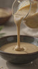 pouring tahini from Ready to Pour Tahini Sauce YOURS